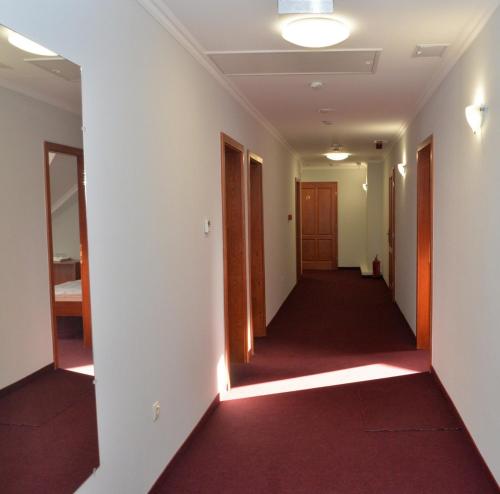 an empty corridor in a building with a hallway at Belvárosi Vendégház in Mór