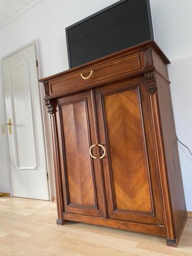 a wooden cabinet with a television on top of it at Römerburg Apartments Antoniusstrasse in Boppard