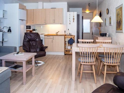 a living room and kitchen with a table and chairs at 4 person holiday home in Vestervig in Vestervig