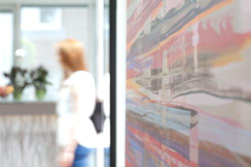 a woman is standing next to a wall at Hotel Bakenhof in Münster