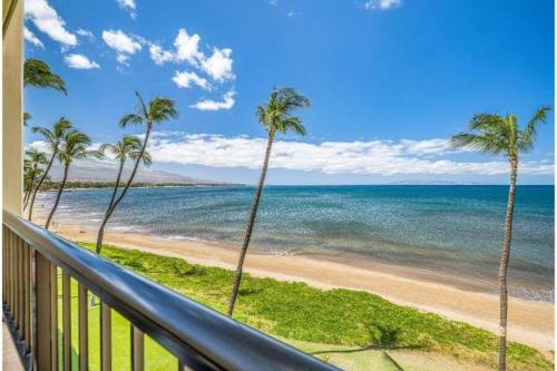 a view of a beach with palm trees and the ocean at SUGAR BEACH RESORT, #418 condo in Kihei
