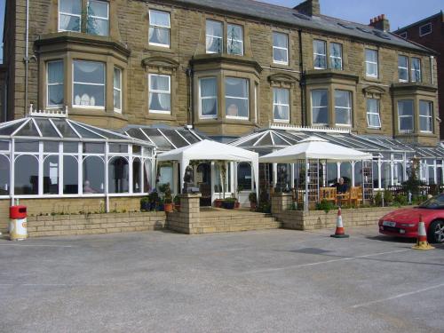 a building with white umbrellas in front of it at Monterey Beach Hotel in Lytham St Annes