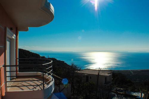 a view of the ocean from a balcony of a house at Apartments Vila Emiliano in Borsh