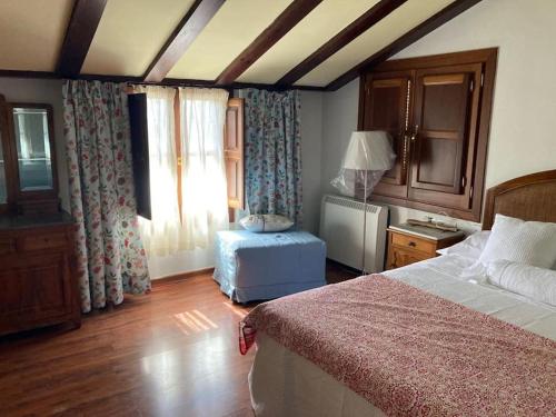 um quarto com uma cama, uma mesa e uma janela em Alfapinoalegre em Alfacar