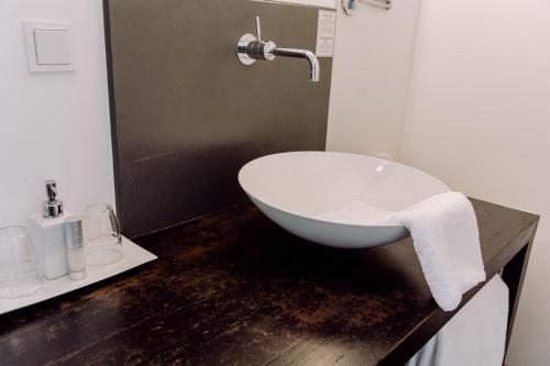 a bathroom with a white bath tub on a counter at Hirzinger - Gasthaus und Hotel in Riedering