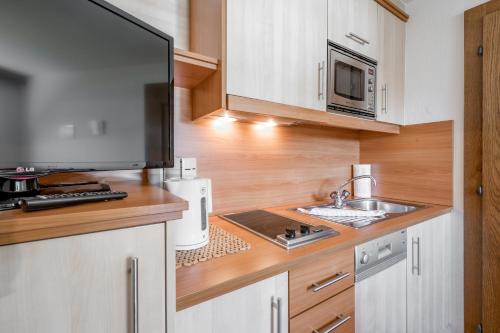 a kitchen with a sink and a microwave at Pension Granbichler in Längenfeld