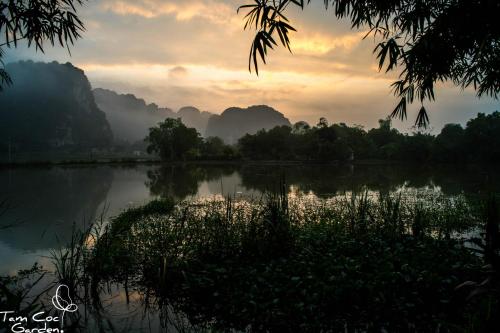 a view of a river with mountains in the background at Tam Coc Garden Resort in Ninh Binh