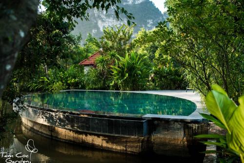 a swimming pool in the middle of a jungle at Tam Coc Garden Resort in Ninh Binh