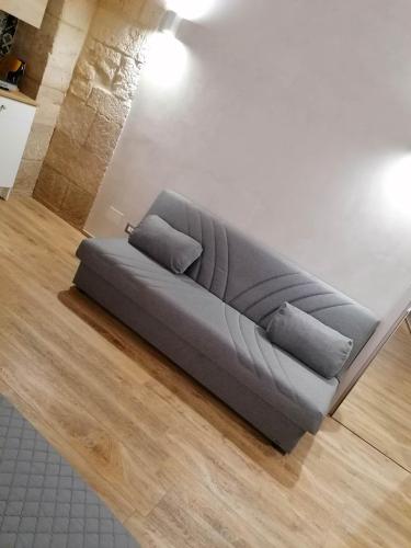 a couch sitting on the floor in a living room at La Dimora del Principe-Piano terra in Trani