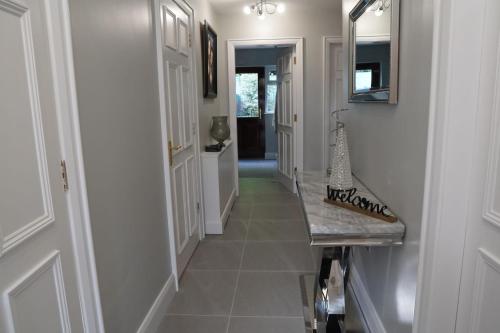 a hallway of a home with a tile floor at St Elmos Townhouse in Derry Londonderry