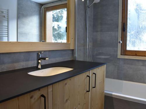 a bathroom with a sink and a mirror at Appartement Méribel, 3 pièces, 6 personnes - FR-1-180-565 in Les Allues