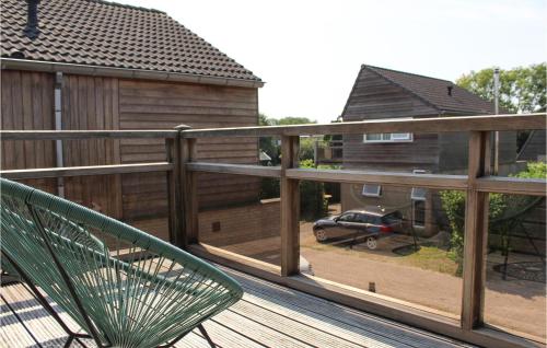 a balcony with a green chair and a house at Amazing Home In Grou With Wifi in Grou