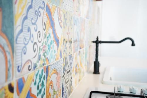 a bathroom with colorful tiles on the wall at Casa d’autore siciliana in Milan