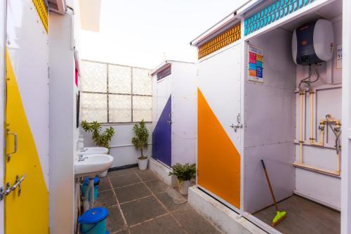 a bathroom with a sink and two toilets at goSTOPS Udaipur in Udaipur