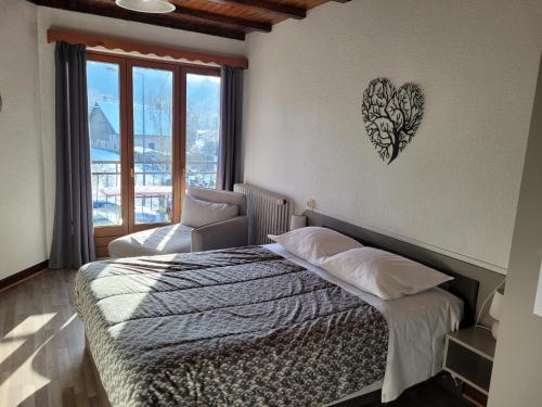 a bedroom with a bed with a heart on the wall at Les Jolis Coeurs in Thiéfosse