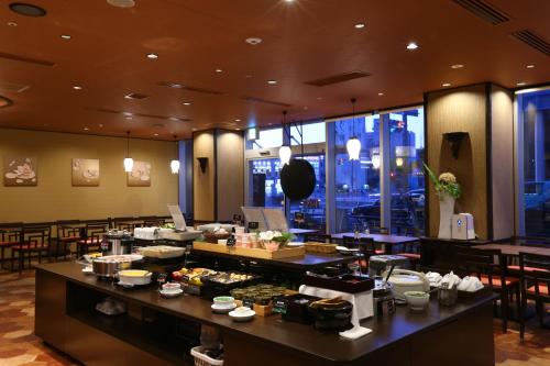 a restaurant with a buffet line with tables and chairs at Daiwa Roynet Hotel Nagoya Taiko dori Side in Nagoya