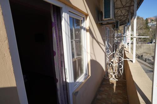 an open door of a building with a window at imperator 1 Hotel in Kutaisi