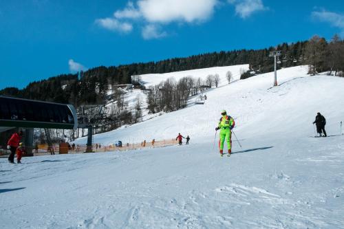 a person is skiing down a snow covered slope at Alpenpension Gasthof in Ratten