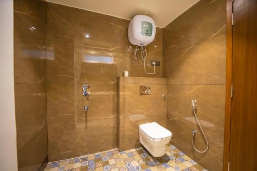a bathroom with a shower with a toilet and a shower at ASHOK VILLA in Jaipur