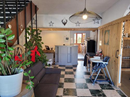 a living room with a couch and a table at Les Jolis Coeurs in Thiéfosse