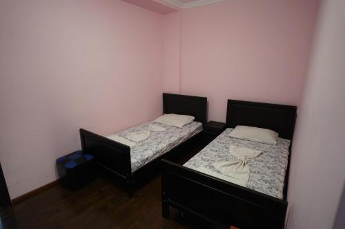 two beds in a small room with two beds sidx sidx sidx at imperator 1 Hotel in Kutaisi