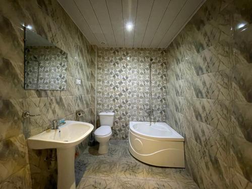 a bathroom with a sink and a toilet at imperator 1 Hotel in Kutaisi