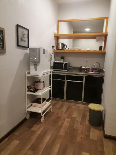 a kitchen with a sink and a microwave at Dzulstudio(Muslim) Nova Highland in Brinchang