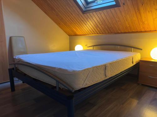 a bed in a room with two lights on it at Vierbarke 73 in Nieuwpoort