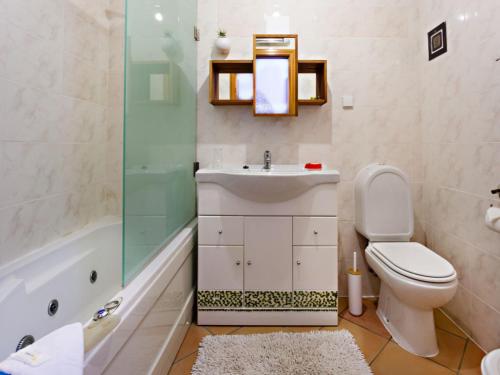 a bathroom with a sink and a toilet and a shower at Alameda Apartment in Faro