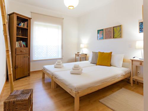a bedroom with a large white bed in a room at Alameda Apartment in Faro
