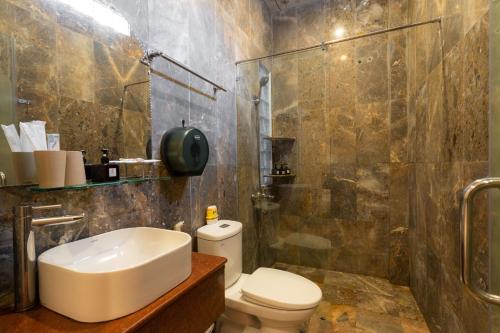 a bathroom with a sink and a toilet and a shower at Hoa My II Hotel in Hoi An