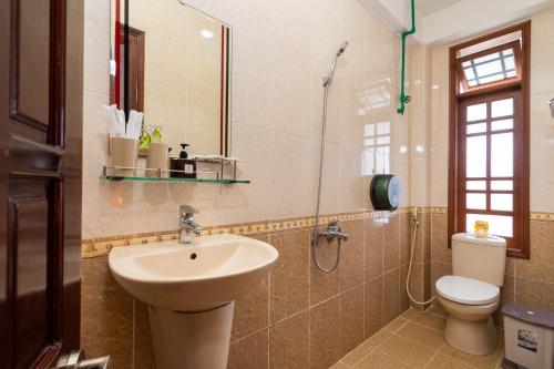 a bathroom with a sink and a toilet at Hoa My II Hotel in Hoi An