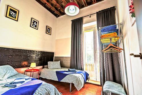 a bedroom with two beds and a window at Milagros Central Apartments in El Puerto de Santa María