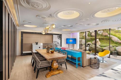 a dining room with a table and chairs at Norbu The Montanna, Dharamshala - IHCL SeleQtions in Dharamshala