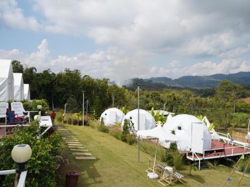a group of white domes in a garden at Yellowstone Camps O2 Zone Khao Kho in Khao Kho