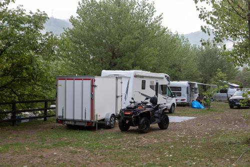 a motorcycle parked in front of a trailer at Camping Alta Ribagorça in El Pont de Suert