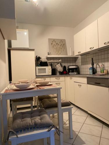 a kitchen with a table and a microwave at Regenbogengasse in Schkeuditz