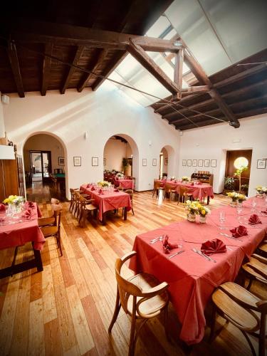 a large room with red tables and chairs in it at Agriturismo Casale Montebello in Monteleone di Spoleto