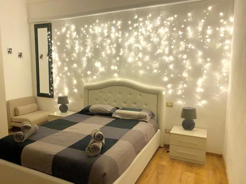 a bedroom with a bed with lights on the wall at Villa Zara in Siena