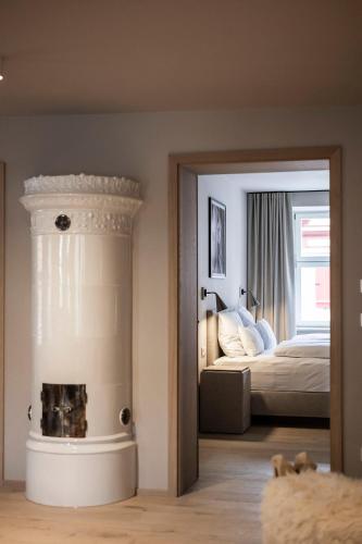 a bedroom with a bed and a fire place at HOTEL & SPA Goldene Rose in Dinkelsbühl