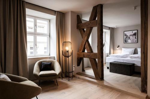 a bedroom with a bed and a large mirror at HOTEL & SPA Goldene Rose in Dinkelsbühl
