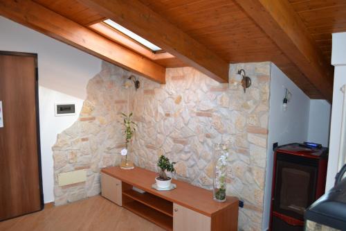 a stone wall in a room with a wooden ceiling at B&B Alina in Catanzaro Lido