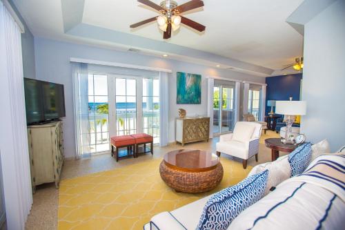 a living room with a couch and a tv at Lawson Rock - Angelfish 203 Condo in Sandy Bay