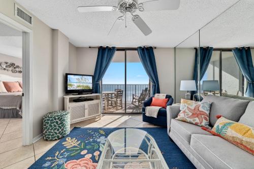 a living room with a couch and a tv at Sunswept 702 condo in Orange Beach
