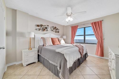 a bedroom with a bed and a window at Sunswept 702 condo in Orange Beach
