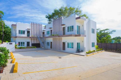 a large white house with a parking lot at Acqua Di Mare #3 condo in Roatan