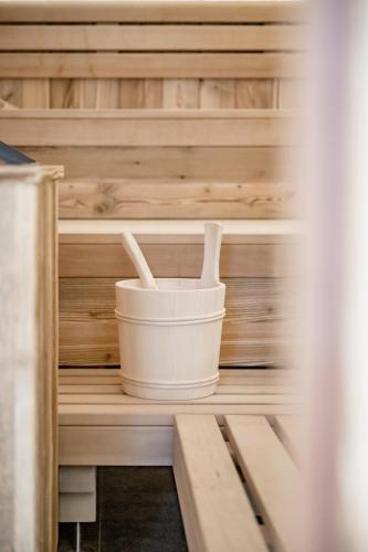 a wooden cabin with a bucket and two utensils at The Moss - Your unique hideaway in Obergurgl