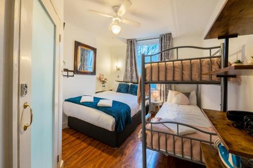 a bedroom with two bunk beds and a door at ND Hotel - Hyde Park in London