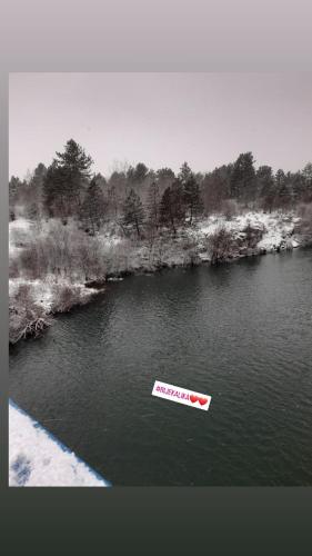 a red and white boat in a body of water at Kuća za odmor Antonija in Gospić