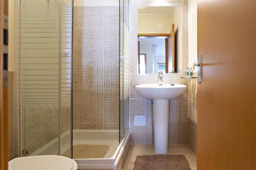 a bathroom with a sink and a shower at Ocean Breeze Apartment in Cabanas de Tavira